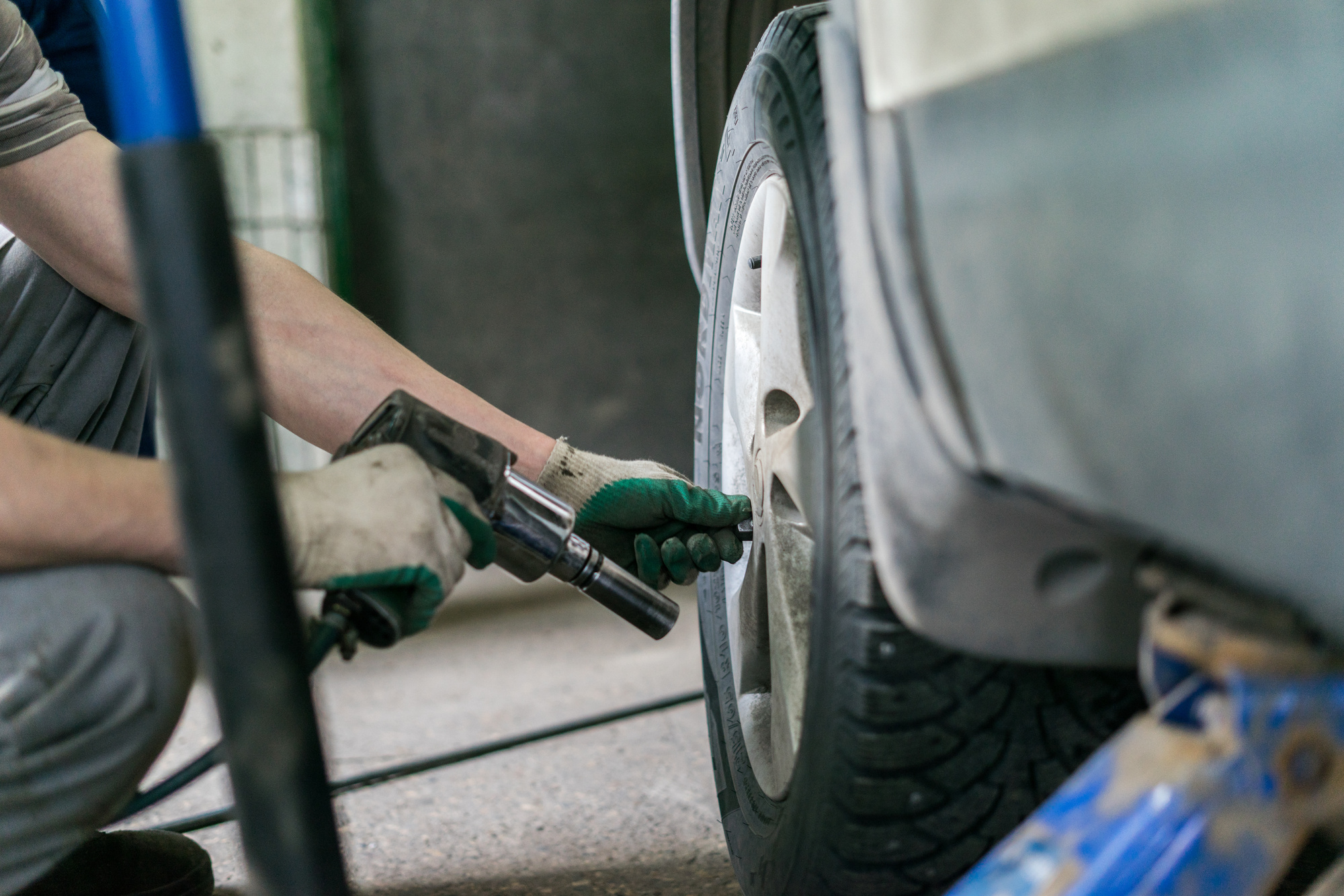 man changing tire on car