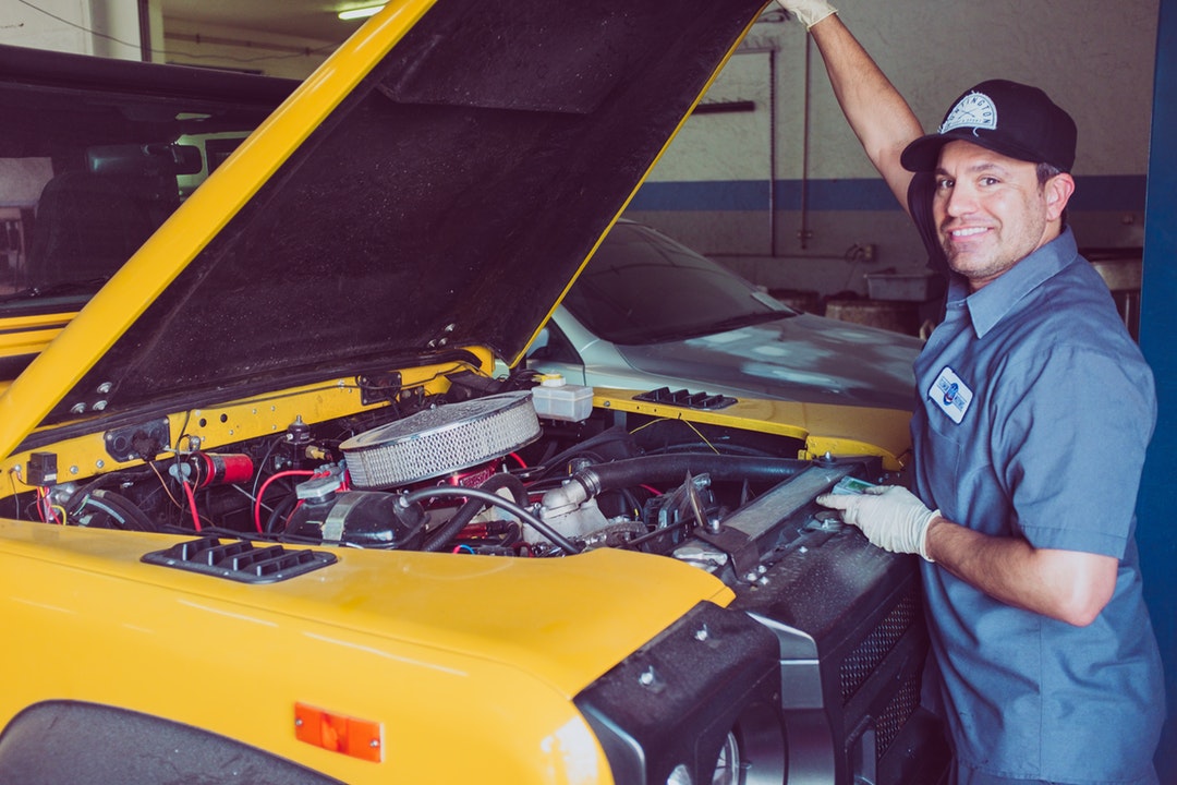 auto repair man working on vehicle