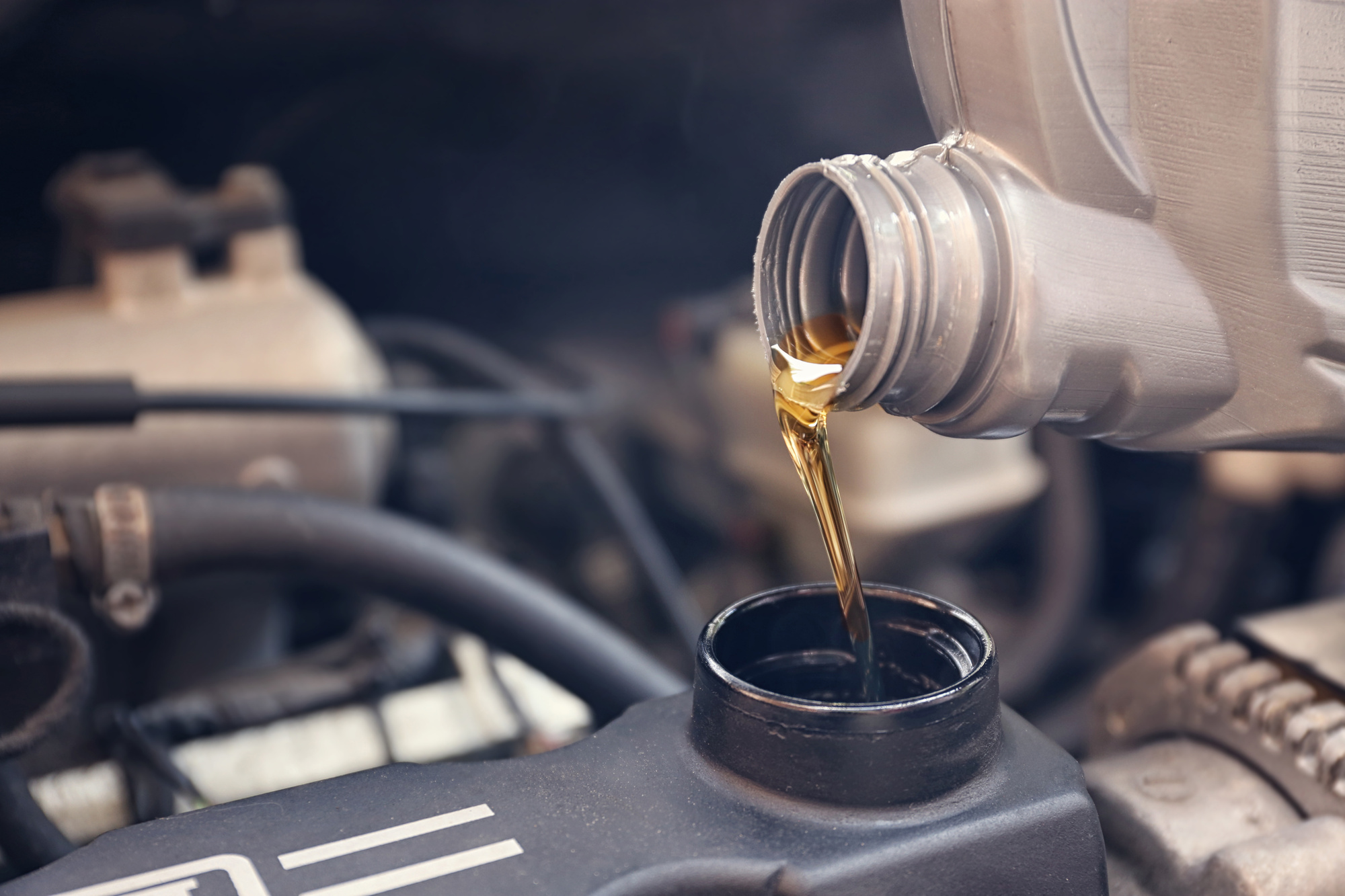 pouring oil into car