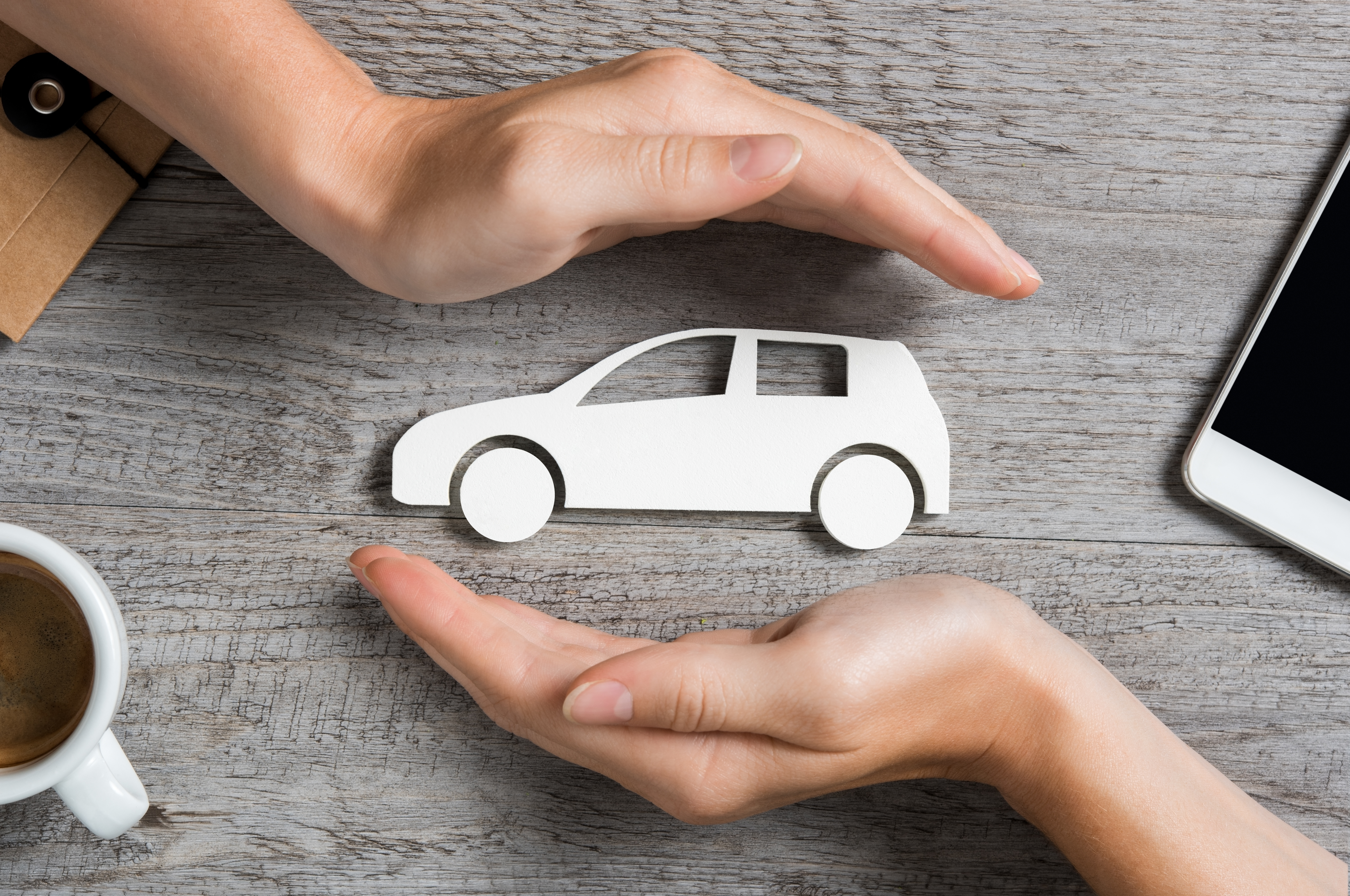 hands protecting car cutout