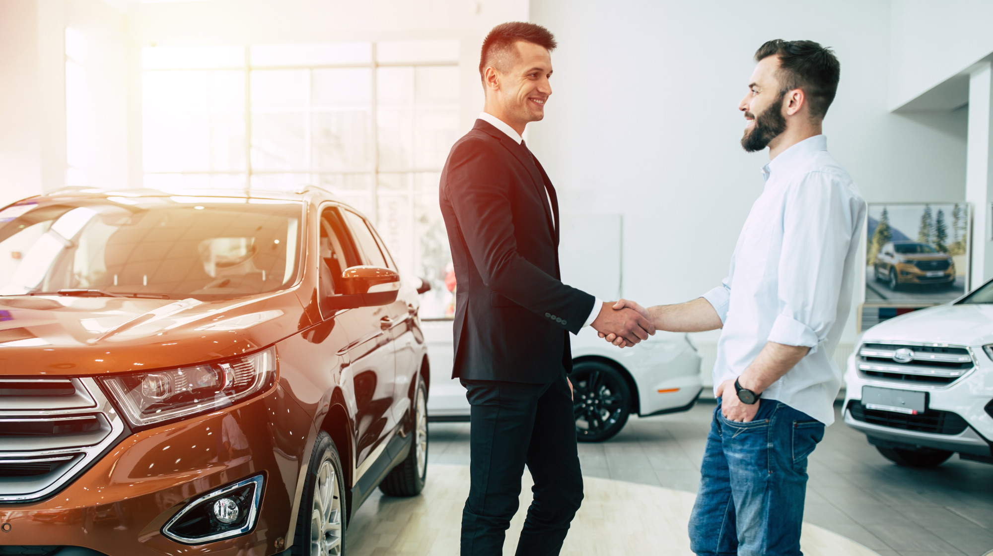 men at car dealership