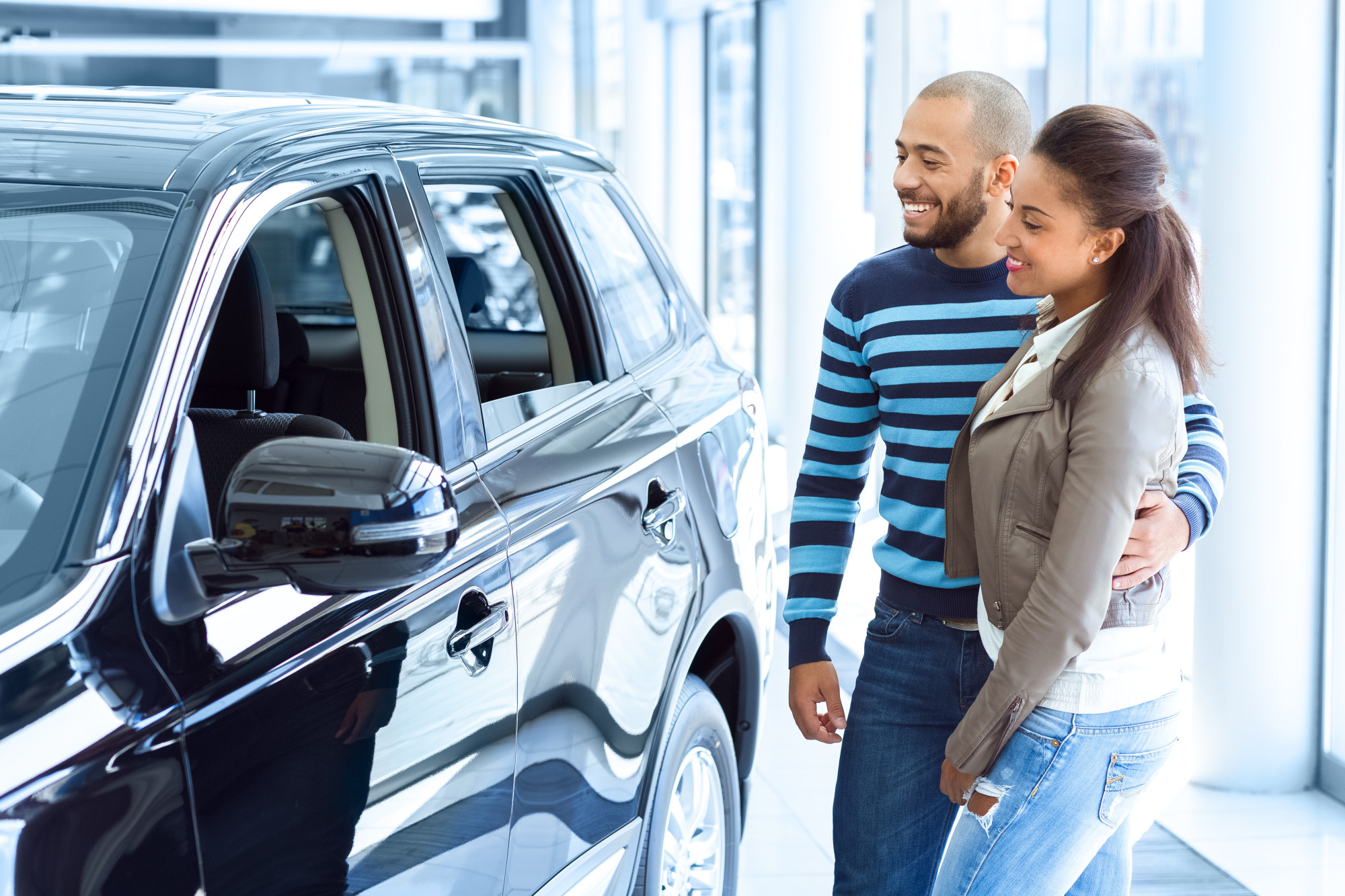 couple shopping for car at dealership