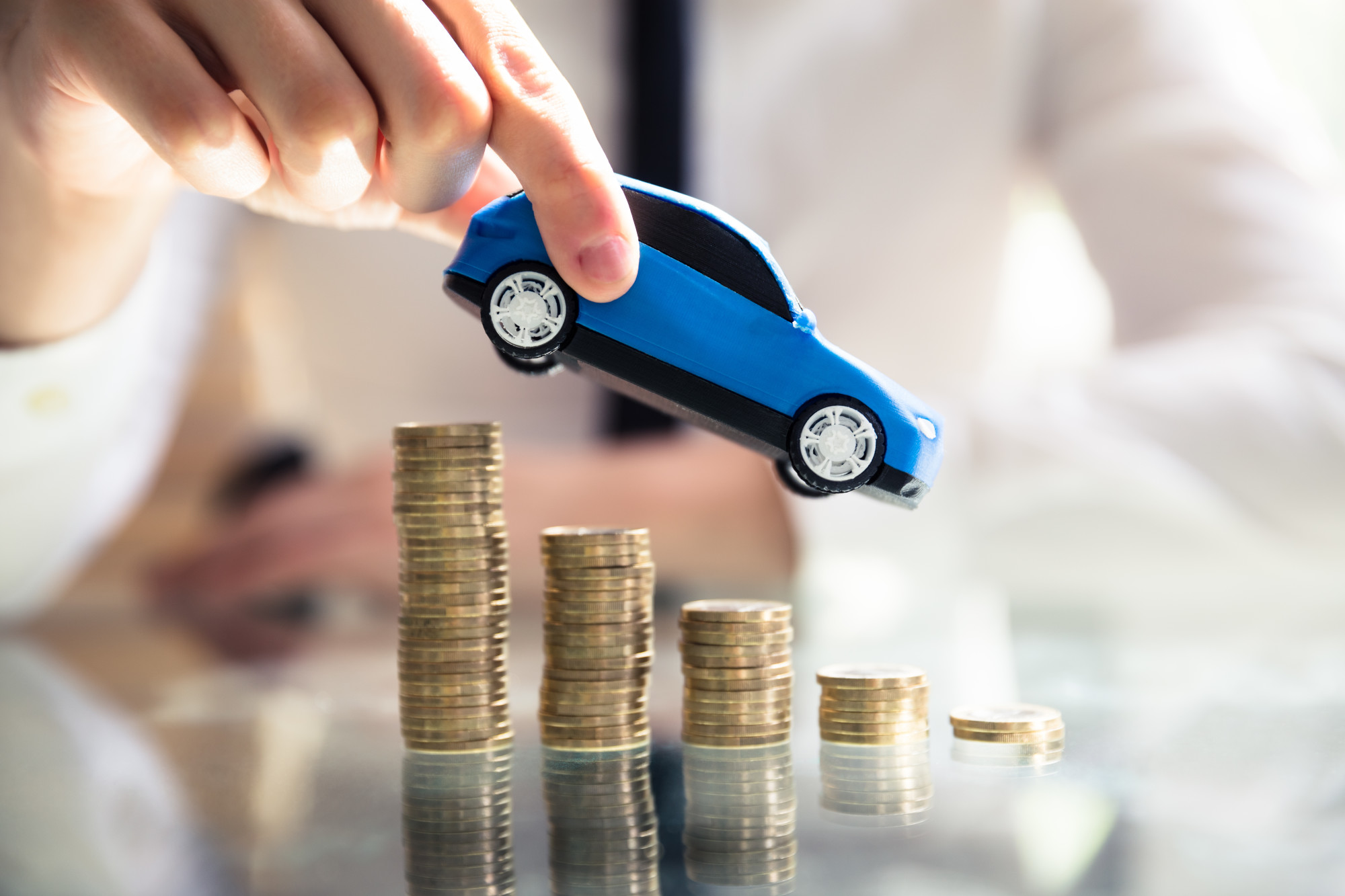 car above stacks of coins