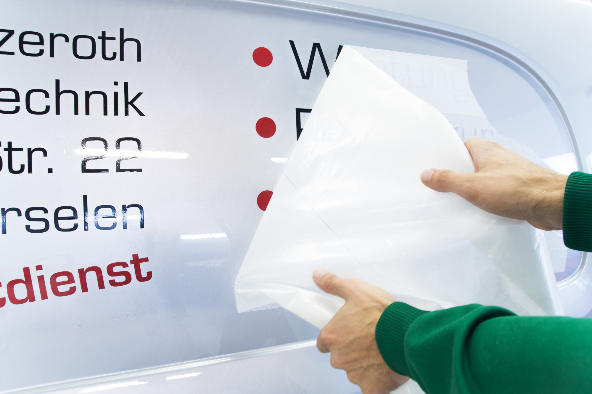 person applying a car decal