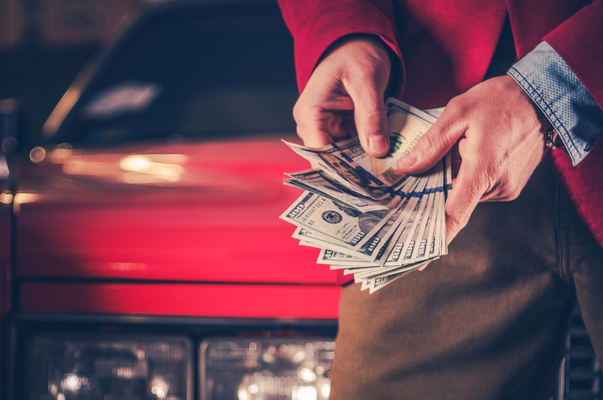 Person Holding Money After Junking His Car