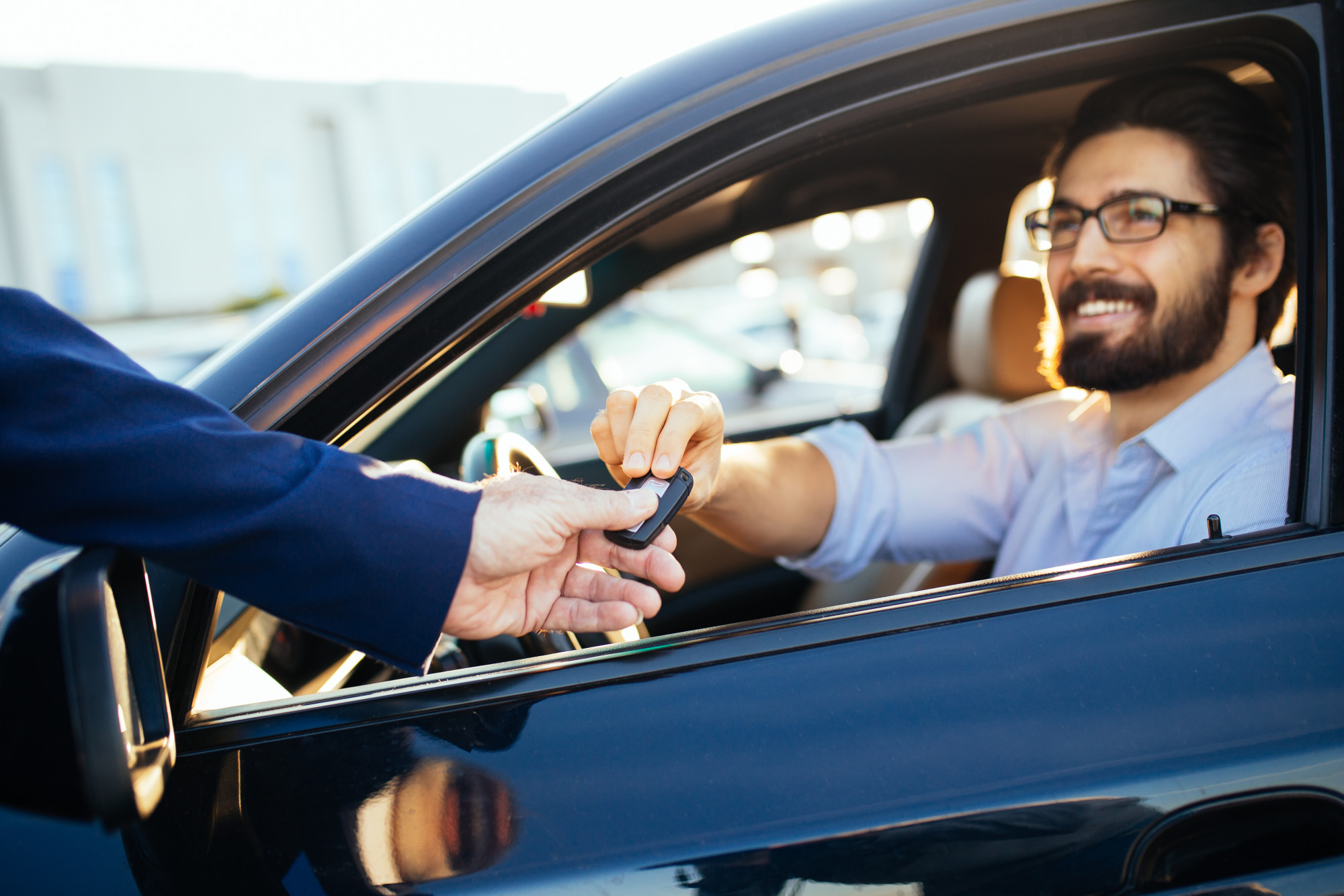 Handing the Key to the Person Who Purchase a Car