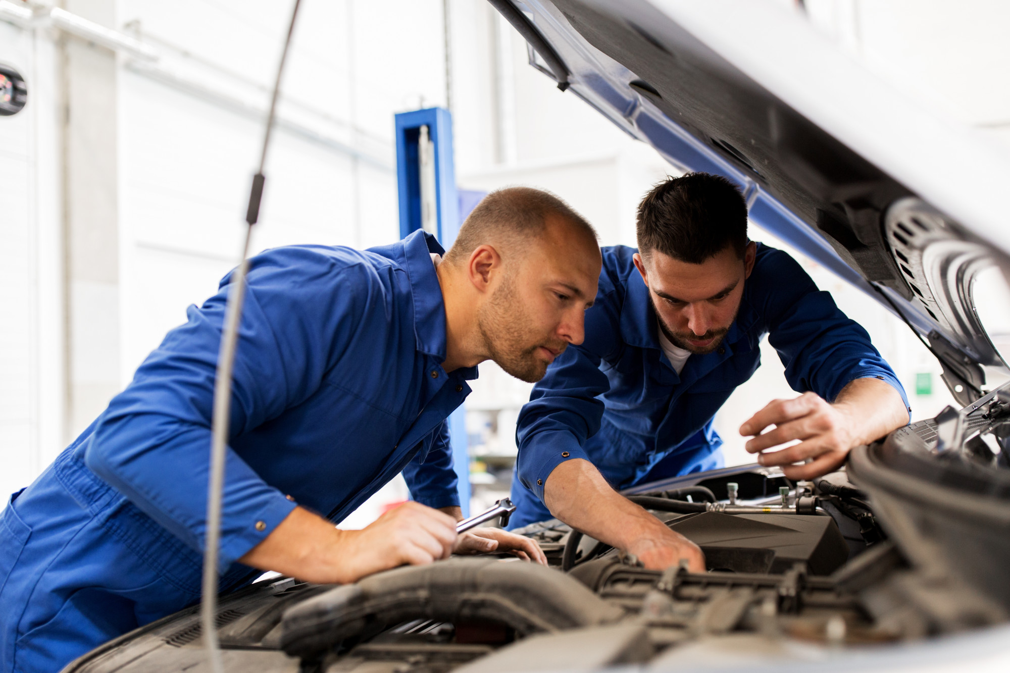 Mechanics Working on a Car Engine